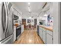 Bright, galley-style kitchen features stainless steel appliances and ample cabinet space, flowing into the dining area at 4846 Colonnades Club Blvd, Lakeland, FL 33811
