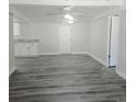 Living room with gray wood floor and white walls at 2434 Trenton E Rd, Lakeland, FL 33815