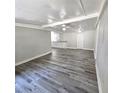 Gray wood floor living room with white walls and ceiling fan at 2434 Trenton E Rd, Lakeland, FL 33815
