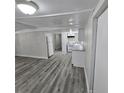 Gray wood floor living room with white walls at 2434 Trenton E Rd, Lakeland, FL 33815