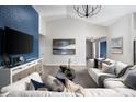 Inviting living room with a large television, comfortable seating, and stylish decor at 6236 Sw 95Th Pl, Ocala, FL 34476