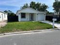 Inviting single-story home with a fresh green lawn and sleek modern design at 209 W 6Th St, Lakeland, FL 33805