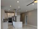 Bright kitchen featuring a quartz island, stainless steel appliances, and modern pendant lighting at 209 W 6Th St, Lakeland, FL 33805