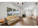 Spacious living room with large windows, wood-look floors, and abundant natural light at 1002 Ne 1St St, Mulberry, FL 33860
