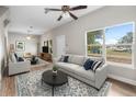 Bright living room with plush seating and large windows at 1002 Ne 1St St, Mulberry, FL 33860