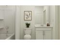 Bright bathroom featuring a shower and tub combination and a modern vanity with storage at 1109 Hour Glass Rd, Lakeland, FL 33801