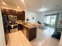 Modern kitchen featuring stainless steel appliances and an open floor plan at 13140 Summerton Dr, Orlando, FL 32824