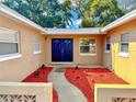Inviting front entrance with double doors, mulch, and landscaping that enhances curb appeal at 5532 Stull Ave, Orlando, FL 32810