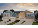 New townhomes show a colorful exterior, driveway, and manicured landscaping at 3775 King Hill Dr, Haines City, FL 33844
