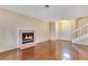 Cozy living room with a fireplace and hardwood floors, illuminated by natural light from the front door at 728 Waterbridge Dr, Winter Haven, FL 33880