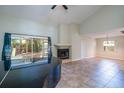 Bright living room boasts a fireplace, high ceilings, and large glass windows with a backyard view at 748 Sagewood Dr, Lakeland, FL 33813
