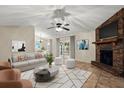 Comfortable living room with brick fireplace, plush seating, and modern decor at 332 Sand Pine Trl, Winter Haven, FL 33880