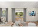Bright living area featuring neutral walls, tile floors, and sliding glass doors at 332 Sand Pine Trl, Winter Haven, FL 33880