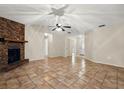 Spacious living room with a brick fireplace, neutral walls, and tile flooring at 332 Sand Pine Trl, Winter Haven, FL 33880