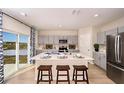 Modern kitchen boasts an island with seating, stainless steel appliances, and a sliding door leading to outdoor views at 4039 Gardenia Ave, Lake Hamilton, FL 33851