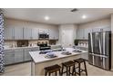 Contemporary kitchen with gray cabinets, stainless steel appliances, quartz countertops, and an island with seating at 4039 Gardenia Ave, Lake Hamilton, FL 33851