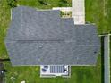 Aerial view of the house with gray shingles, patio set and green grass at 4730 Se 141St Pl, Summerfield, FL 34491