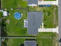 Aerial view of home showcasing the large backyard with a deck and above-ground pool at 4730 Se 141St Pl, Summerfield, FL 34491