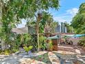 Backyard with a patio, tiled flooring, partial shade, and lush landscaping at 536 Ave G Se, Winter Haven, FL 33880
