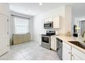 Bright, modern kitchen featuring stainless steel appliances and ample counter space at 800 Reggie Rd, Winter Haven, FL 33884