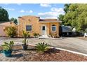 Quaint stucco home with a well-maintained front yard and an inviting, storybook appearance at 1852 E Fern Rd, Lakeland, FL 33801