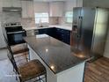 Modern kitchen with stainless steel appliances, an island, and updated countertops at 2212 Ne 11 Ct, Ocala, FL 34470