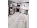 Updated kitchen boasts stainless steel appliances, modern countertops and stylish grey cabinetry at 312 Dorothy Ave, Daytona Beach, FL 32117