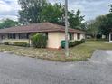 Exterior view of a well-maintained home with manicured landscaping and a tidy lawn at 42 Villa Villar Ct # 420, Deland, FL 32724