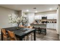 Open dining room and kitchen area with seating for four, and stainless steel appliances at 1629 Sage Ave, Haines City, FL 33844
