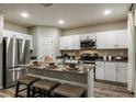 Well-equipped kitchen features stainless steel appliances, white cabinets, and central island at 1629 Sage Ave, Haines City, FL 33844