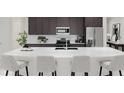 Modern kitchen featuring a large island, stainless steel appliances, and dark brown cabinetry at 5048 Barnet Dr, Davenport, FL 33837