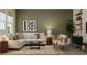 Cozy living room with a white sectional sofa, stylish coffee table, and earth-tone decor at 5048 Barnet Dr, Davenport, FL 33837