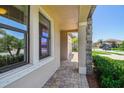 Exterior facade featuring stone accents and a brick paver walkway leading to the front of the home at 1839 Via Lago Dr, Lakeland, FL 33810