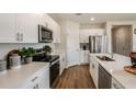 Well-lit kitchen boasts stainless appliances, white cabinetry, ample counter space, and convenient island at 3762 King Hill Dr, Haines City, FL 33844