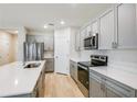 Stylish kitchen with stainless appliances, quartz countertops, and modern cabinets at 3782 King Hill Dr, Haines City, FL 33844