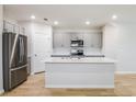 Modern kitchen featuring gray cabinetry, stainless appliances, and hardwood floors at 3782 King Hill Dr, Haines City, FL 33844