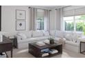 Bright living room features an oversized sectional sofa and plenty of natural light at 1829 Fulfillment Dr, Kissimmee, FL 34744