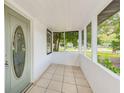 Inviting screened porch with tile flooring, perfect for enjoying the outdoors at 211 W Crescent Dr, Lakeland, FL 33805