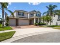 Charming two-story home featuring a brick driveway, lush landscaping, and a spacious three-car garage at 4950 Chase Ct, St Cloud, FL 34772