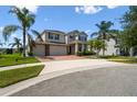 Charming two-story home featuring a brick driveway, lush landscaping, and a spacious three-car garage at 4950 Chase Ct, St Cloud, FL 34772