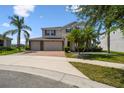 Well-maintained two-story home with a three-car garage, brick driveway, and lush landscaping in a sunny neighborhood at 4950 Chase Ct, St Cloud, FL 34772