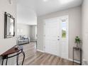 Welcoming entryway with wood flooring and a view into the living area at 3839 White Ibis Rd, Lakeland, FL 33811