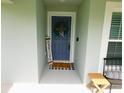 A blue front door welcomes visitors into the home at 206 Samantha Ave, Auburndale, FL 33823