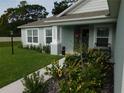 The home has a welcoming walkway, lush lawn and landscaping with beautiful accents at 206 Samantha Ave, Auburndale, FL 33823