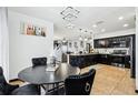 Eat-in kitchen with dark cabinets, stainless appliances, granite countertops, and pendant lighting at 4422 Evergreen Forest Loop, Kissimmee, FL 34758