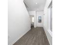 Inviting foyer featuring wood-look flooring, a modern front door with glass, and ample natural light at 13291 Tula Loop, Astatula, FL 34705