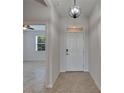 Welcoming entryway with tiled floors, a stylish light fixture, and access to the living areas at 2612 Canyon Crest Dr, Lakeland, FL 33811