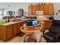 Kitchen area includes appliances, wooden cabinets, and an eating space at 451 Peace Ct, Kissimmee, FL 34759