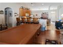 Living room next to open kitchen with wooden cabinets, and laminate flooring at 451 Peace Ct, Kissimmee, FL 34759