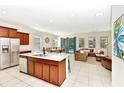 Open-concept kitchen and living area, featuring an island with barstool seating at 5247 Wildwood Way, Davenport, FL 33837